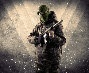 Portrait of a dangerous masked armed soldier with grungy background