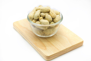 Fresh peanut on glass bowl over white background