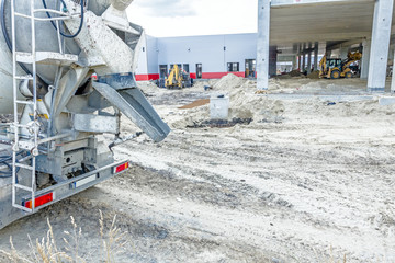 Back side view on concrete mixer, ready for pouring into transporter