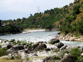 Fototapeta na wymiar Flowing river with rocks and stones