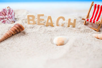 Summer holiday decoration with  beach wooden text, beach chair and sea shall on white sand beach with tropical blue sea and clear blue sky,Image For Love summer holiday vacation travel Concept.