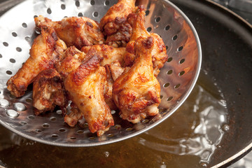 Fried chicken wings in the pan