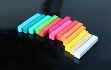 Fototapeta premium Colorful chalk on black background.
