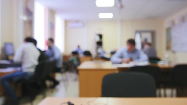 Business people working in office, de-focused