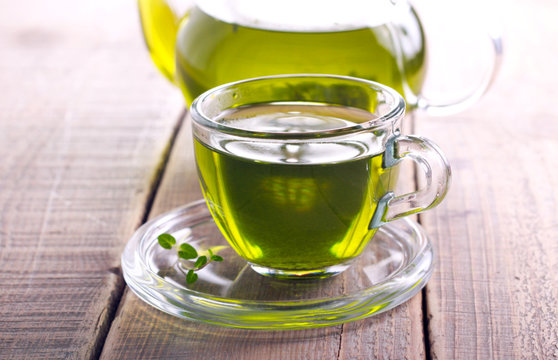 Green herb tea in glass cup
