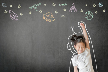 Creative innovation educational conceptual idea with happy little asian girl kid in astronaut suit doodle drawing, universe space out of earth planet on school class chalkboard chalk board background - obrazy, fototapety, plakaty