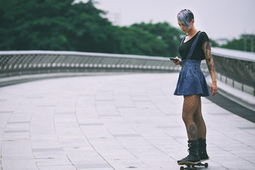 Female skater with smartphone