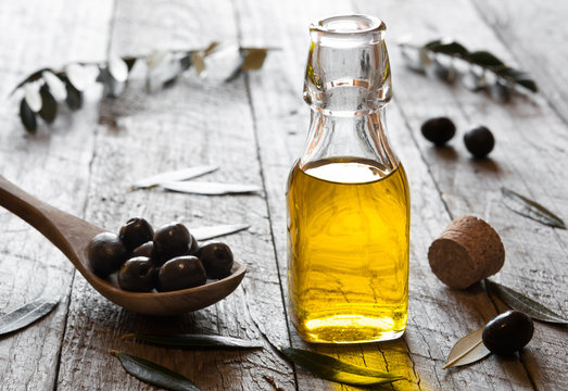 Olive oil with leaves and olives
