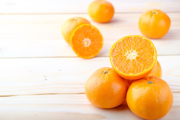 Fresh oranges cut on wooden background