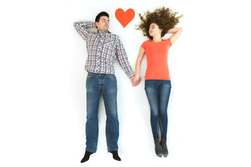 The couple sleeping near the heart sign. View from above