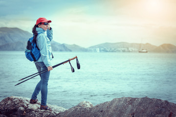 Woman Traveler with Backpack hiking in Mountains with beautiful summer landscape on background mountaineering sport lifestyle concept