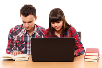 Teenagers studying together with a laptop