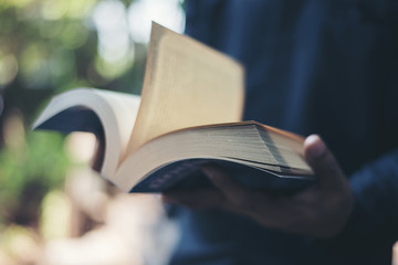 Close up of woman's hands while holding book to reading.