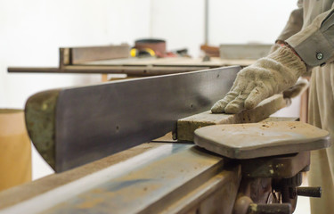 The carpenter was working furniture wood in studio , Soft-focus image