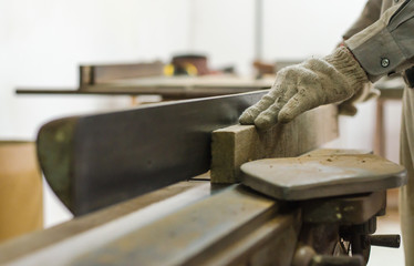 The carpenter was working furniture wood in studio , Soft-focus image