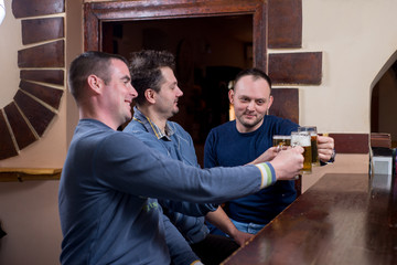 Friends are enjoying beer in bar