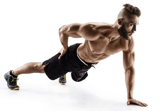 Attractive man doing push-ups exercises from the floor on the left arm. Photo muscular man isolated on white background. The strength and motivation