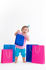 Sweet girl in pink and blue design with paper bags isolated on white background.