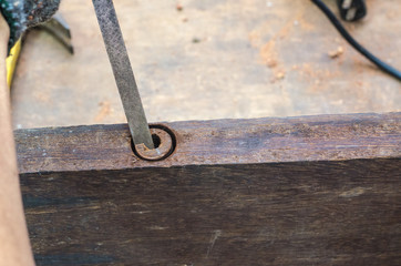The carpenter was working furniture wood in studio , Soft-focus image
