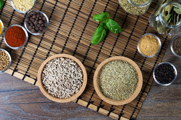 Various fresh spices in bowls, wooden background, 