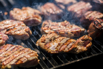 Hot meat is cooked on the grill