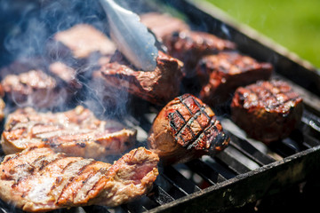 Hot meat is cooked on the grill