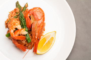 rice with shrimp and asparagus in a tomato sauce.