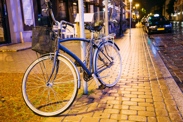 Fototapeta na wymiar Bicycle Bike Parking On Street In Old Part European Town In Summer
