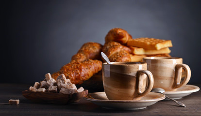 Breakfast with black coffee and fresh pastries