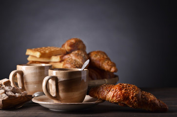 Breakfast with black coffee and fresh pastries