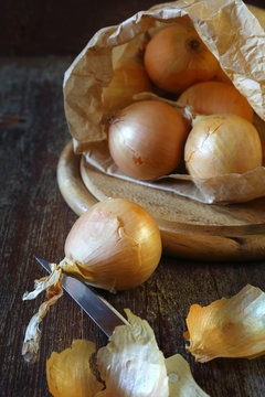 Golden onion on wooden surface