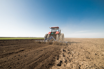 Fototapeta premium Tractor preparing land