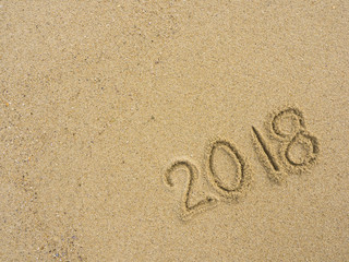 Fototapeta na wymiar New year 2018 texture on sand