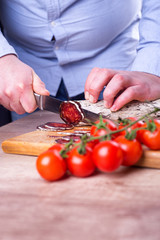 Man is cutting sausage