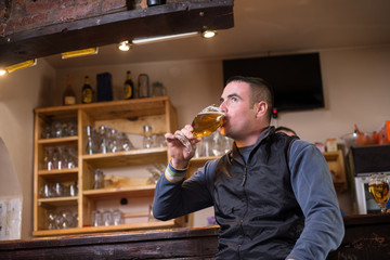 Man is enjoying in drink at bar