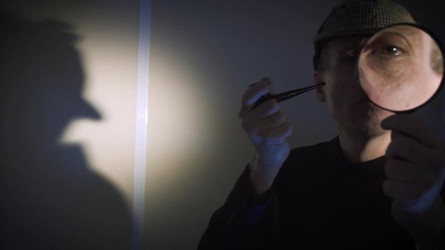 sherlock holmes in studio detective at work with magnifying glass and pipe