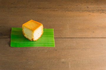 Sliced butter cake on wooden background