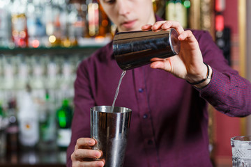The bartender making cocktail