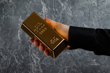 Hand with a gold bar