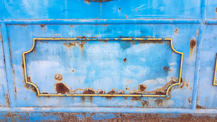 Abstract iron wheel with rush metal door in abadon place