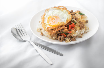 Fried basil leave with meat, Fried egg on rice spicy thai food.