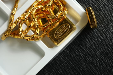 The gold bar put on the dark background represent gold and business finance concept related idea.