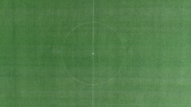 Footage of a center of a football stadium, the shot is moving away from above the center and rotates...