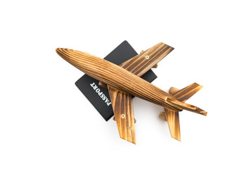 top view airplane model on top of a passport on white background