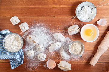 Cooking different types of dumplings: chinese, gyoza (gedza), dim-sum, manty. Top view, copy space