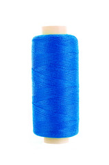 bobbin of blue thread isolated on the background