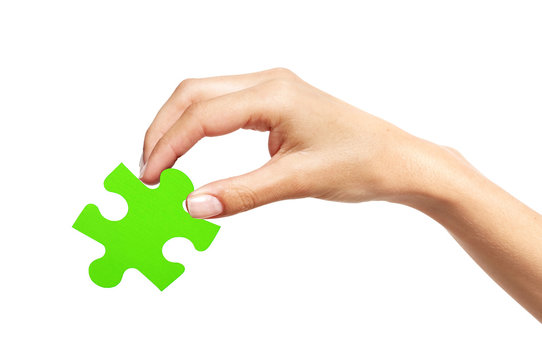Green puzzle with woman hand isolated on white background