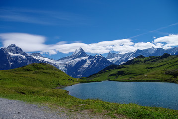 Fototapeta na wymiar Sunny day view to the mountains Bachalpsee lake. Mannlichen (Jungfrau region, Bern, Switzerland)