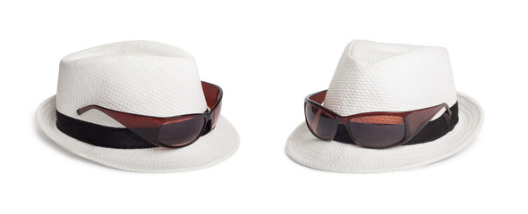 Sunglasses and a white summer hat on an isolated background