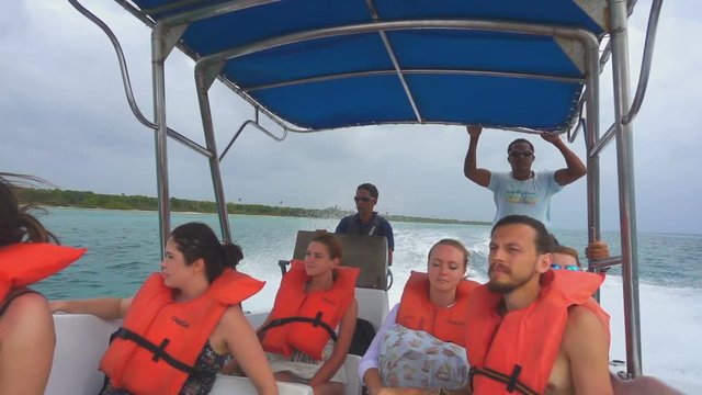 The tourists on a boat floating on the ocean in slow-motion